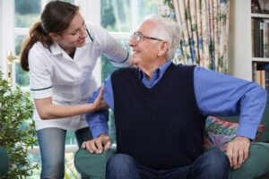 An older adult calmly packing belongings with supportive family members in a cozy living room.