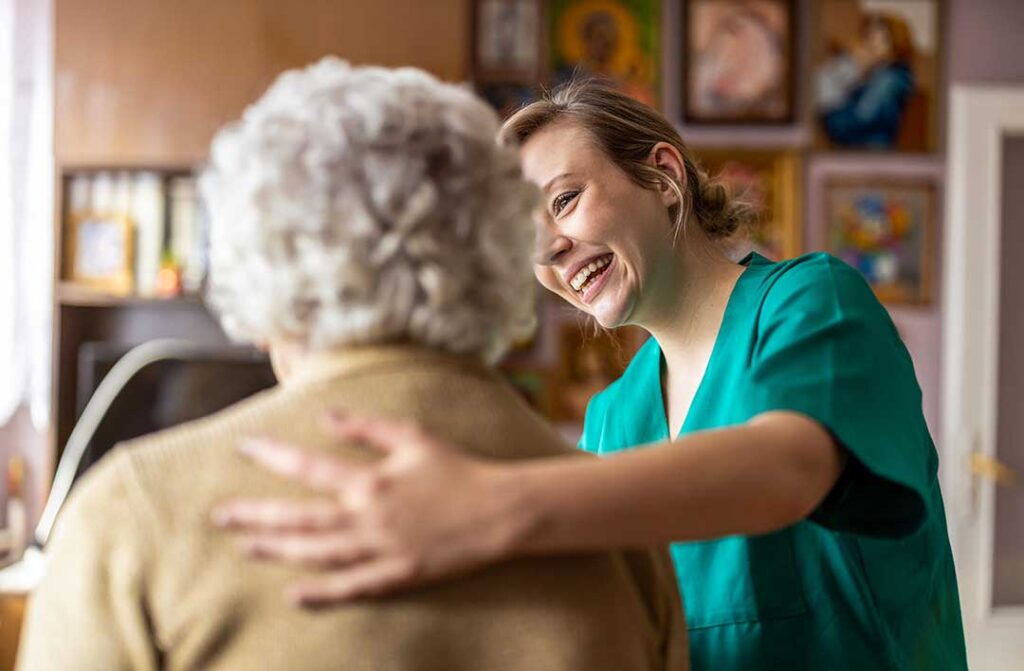 Older adult choosing an activity from a daily schedule with a caregiver in a bright common room.