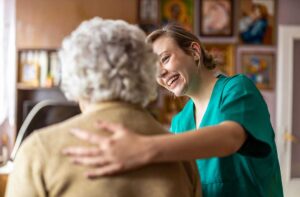 Older adult choosing an activity from a daily schedule with a caregiver in a bright common room.